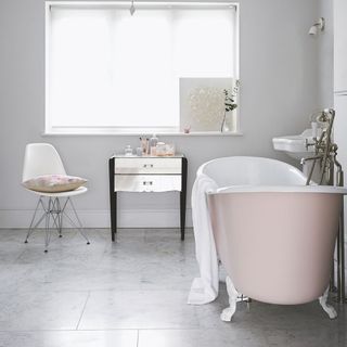 modern bathroom with marble flooring and chair