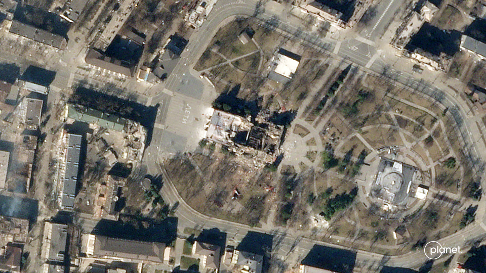 This photo taken by a Planet satellite on March 21, 2022 shows a destroyed theater in the Ukrainian city of Mariupol.  The Russian world for 