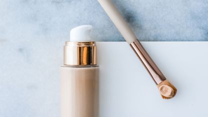 foundation in a bottle with a foundation brush at the side