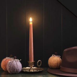 Pink taper candle with pumpkins