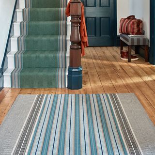 stairs and hallway runner in coordinating striped designs