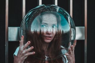 Thoughtful Young Woman Wearing Glass Helmet In Head