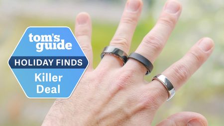 A hand wearing three popular smart ring models