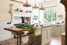 kitchen with brass lighting and central island in rectory house