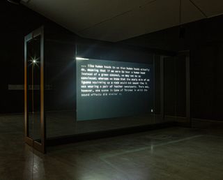 Poignant written testimony appears on a screen in a blackened room, to a soundtrack of audio cues made by Abu Hamdan