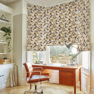 An office set up in a bay window in a bedroom