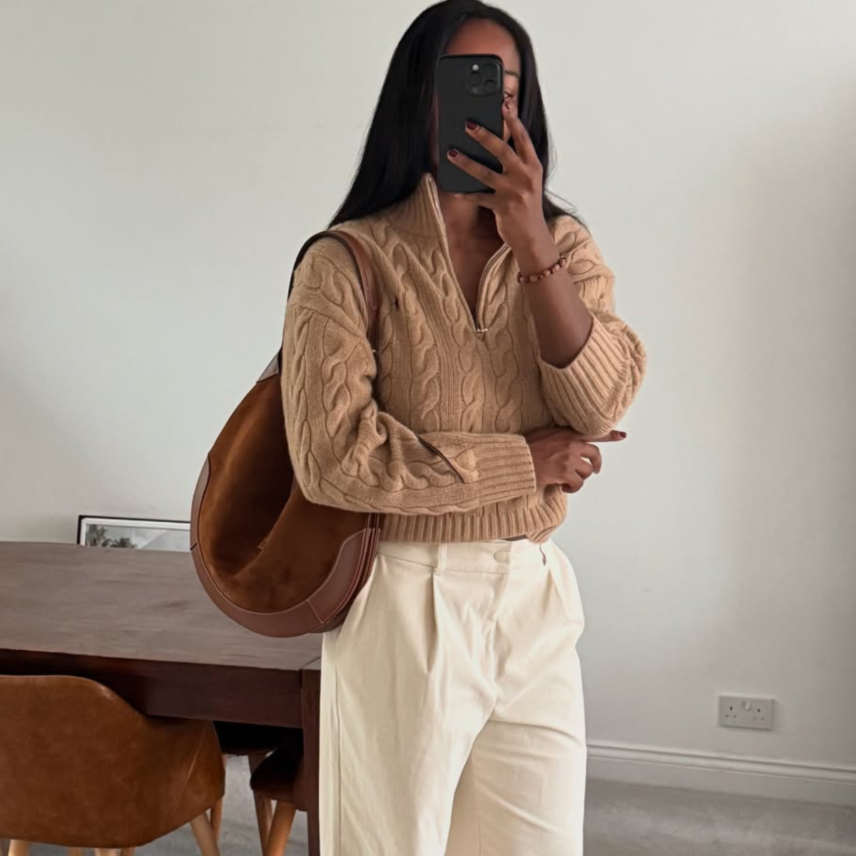 @nlmarilyn wears brown suede bag, brown jumper, cream jeans