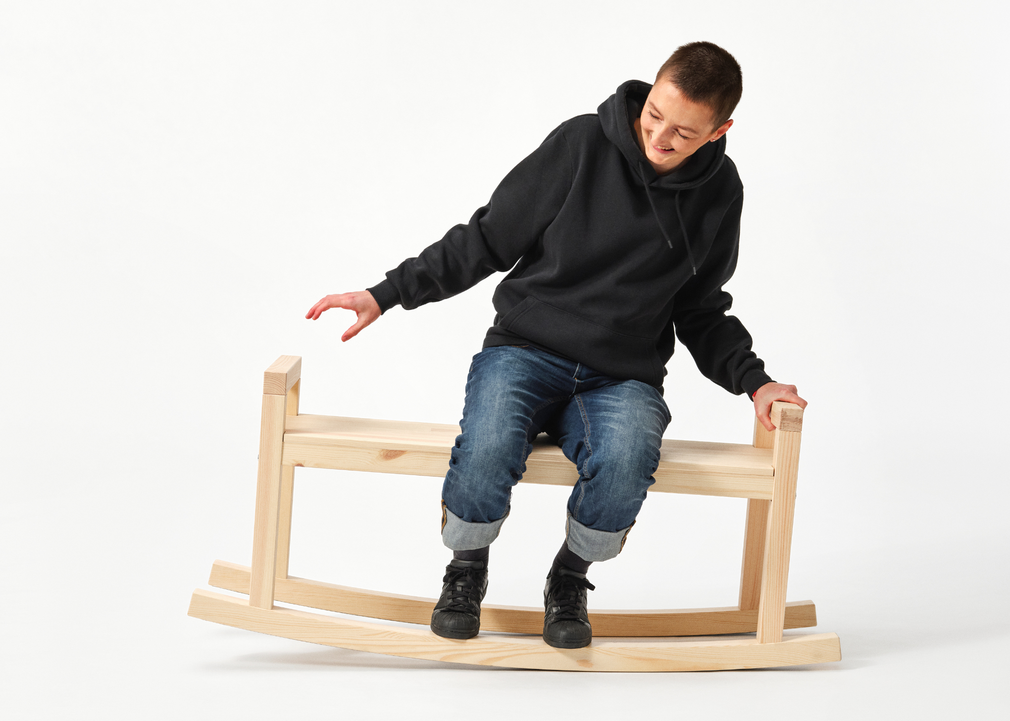 IKEA PS collection rocking bench with the designer sat on it