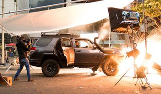 A car explodes on the set of Mile 22