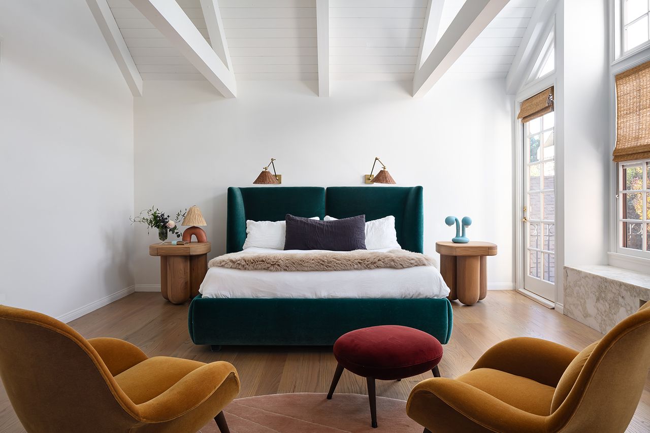 white bedroom with a modern bed and table lights with jewel colors