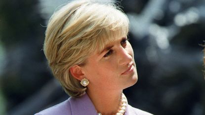 Diana, Princess of Wales, a key volunteer of the British Red Cross Landmine Campaign listens to speaker Ken Rutherford who was injured by a land mine in Somalia at ceremonies at Red Cross headquarters in Washington DC 17 June 1997