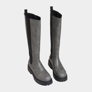 flat lay image of grey knee high boots