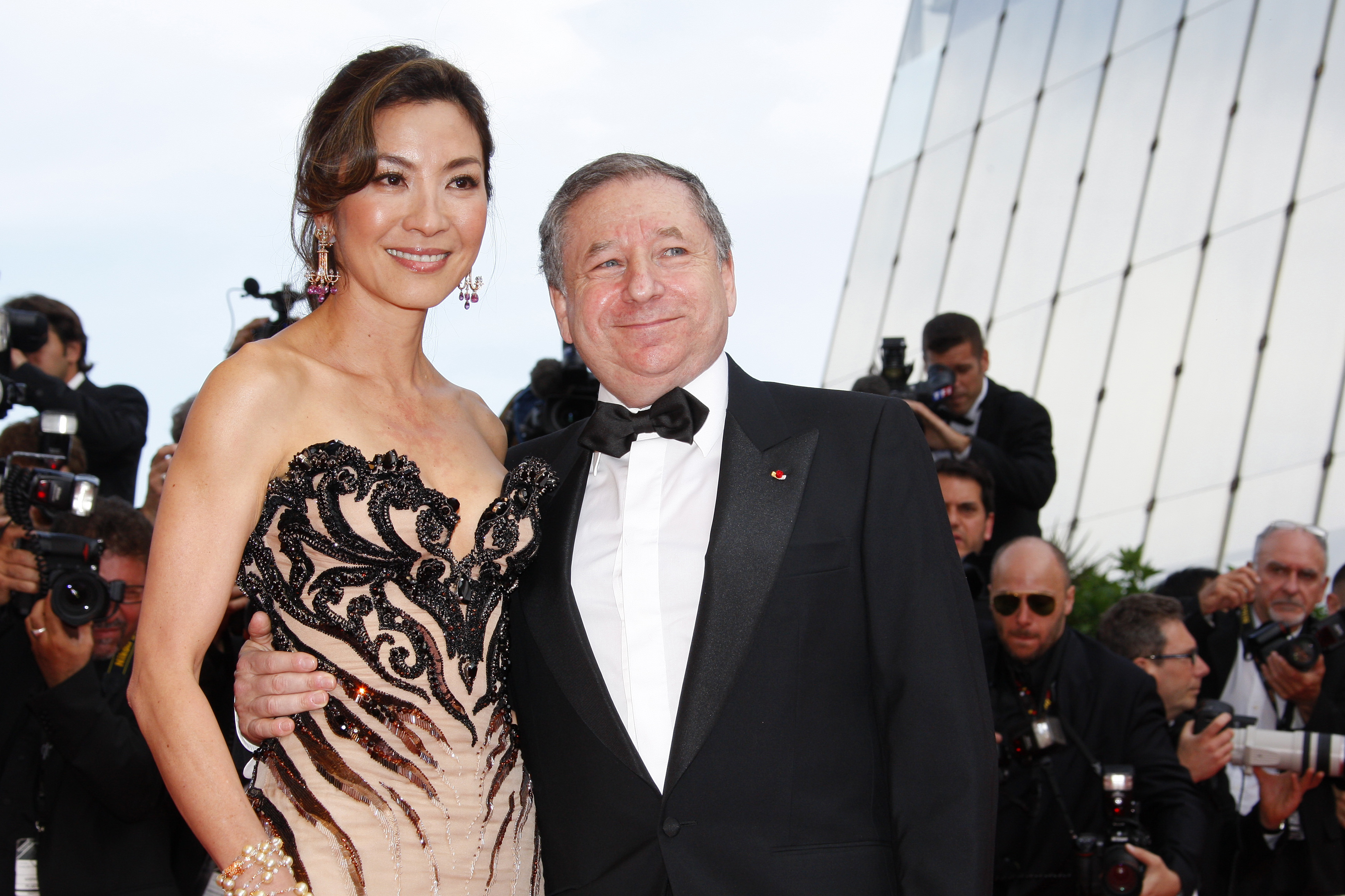 a photo of Michelle Yeoh and her partner Jean Todt posing on a red carpet in 2009