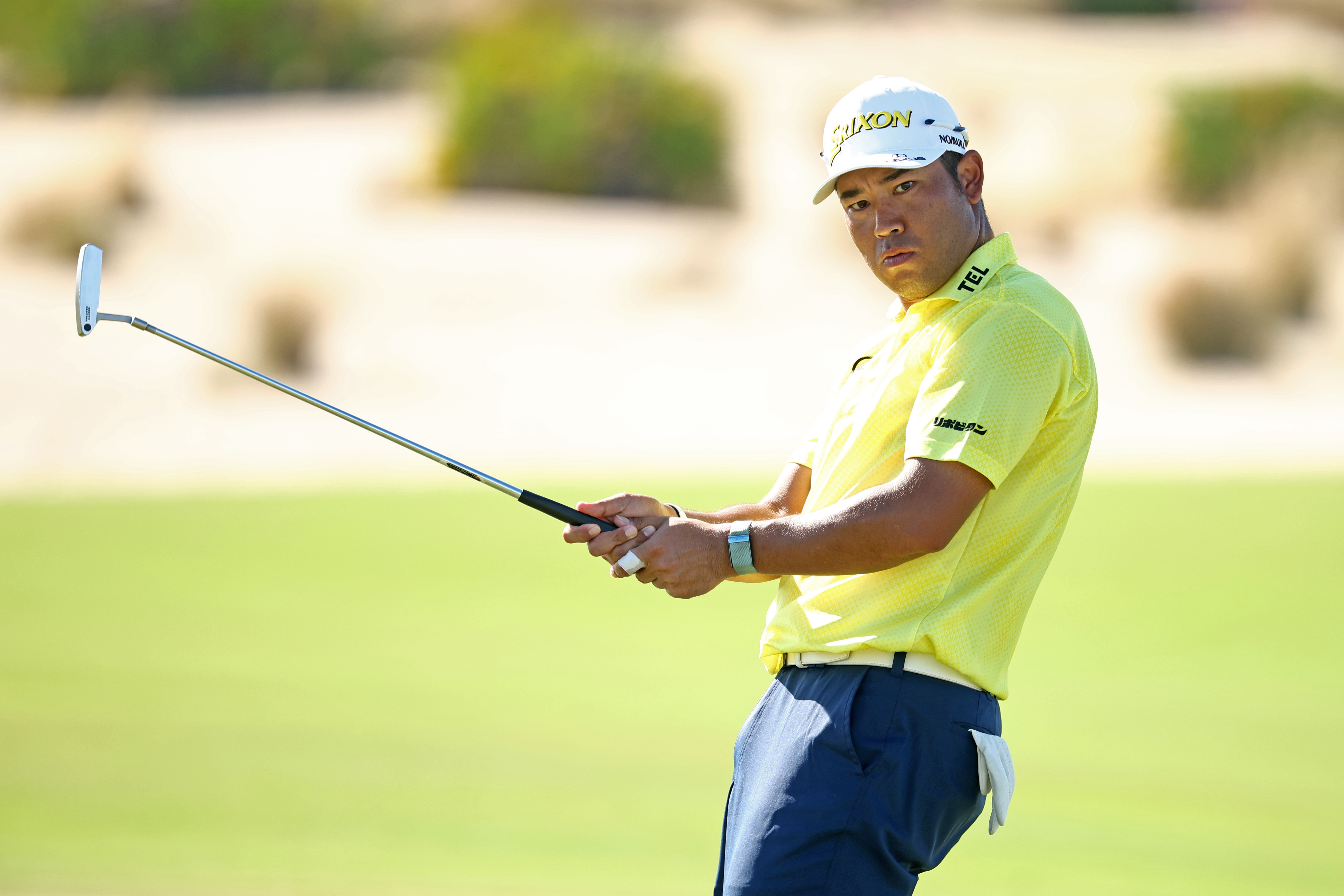 Hideki Matsuyama watches his putt