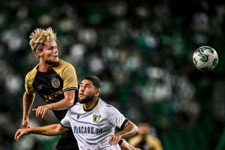 Sporting's Danish midfielder #42 Morten Hjulmand (L) heads the ball with Famalicao's Spanish forward #11 Oscar Aranda during the Portuguese league football match between Sporting CP and FC Famalicao at Alvalade stadium in Lisbon on August 27, 2023.