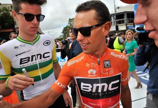 BMC Racing riders Miles Scotson (L) of Australia and Richie Porte (C) of Australia sign on prior to the start of stage four of the Tour Down Under