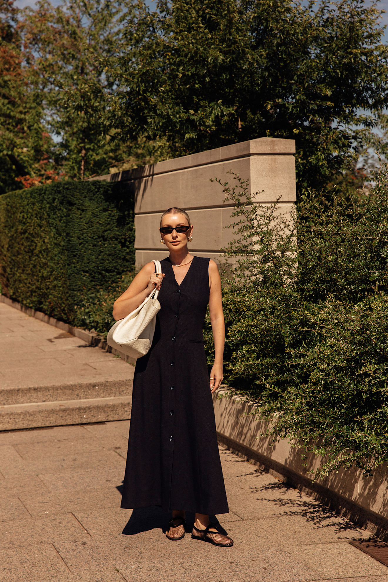 woman wearing a black dress and mesh flats