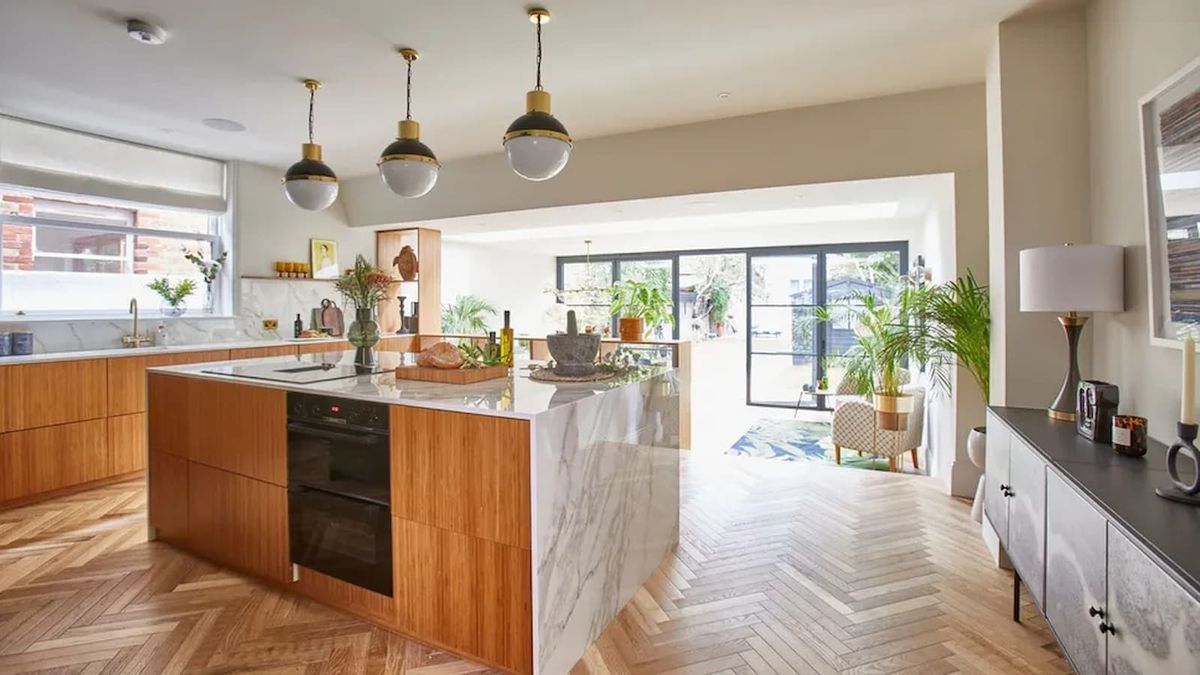 A white marble kitchen worktop above a stove as part of kitchen extension