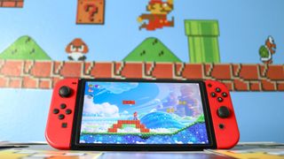 Super Mario Bros. Wonder on a Nintendo Switch with a Mario-themed wall in the background