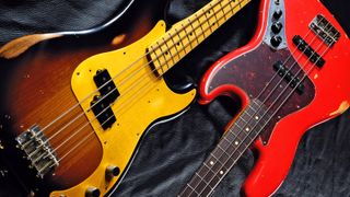 Fender Jazz Bass and Precision Bass on dark ground