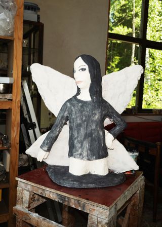 Ceramic sculpture of a woman with wings