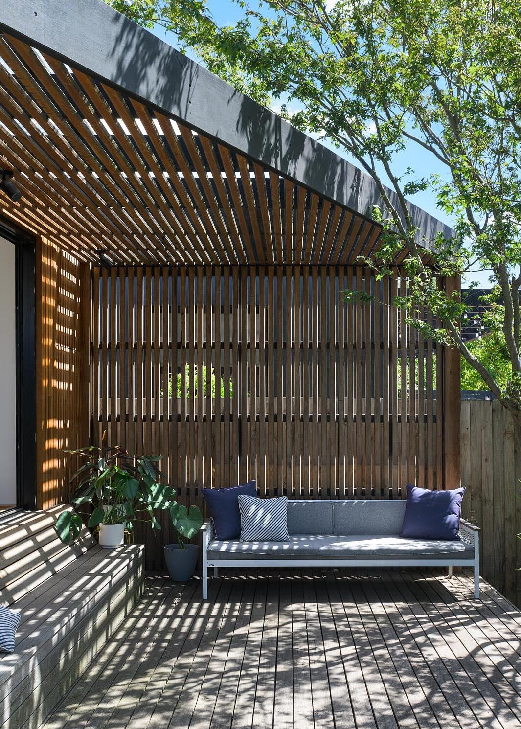 Stylish deck with timber slatted back wall and triangular roof