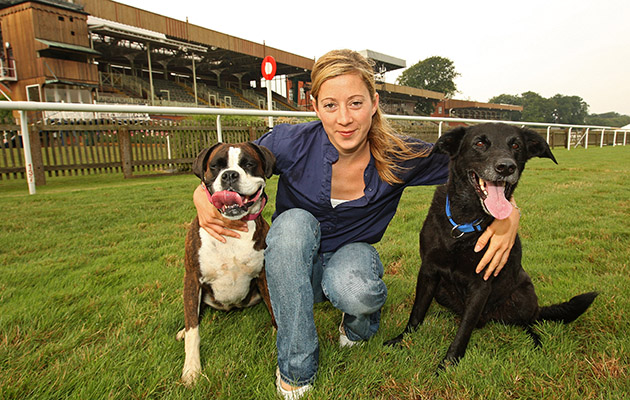 JOCKEY HAYLEY TURNER ON NEWMARKET RACECOURSE WITH HER DOGS JET AND HOLLY.jpg