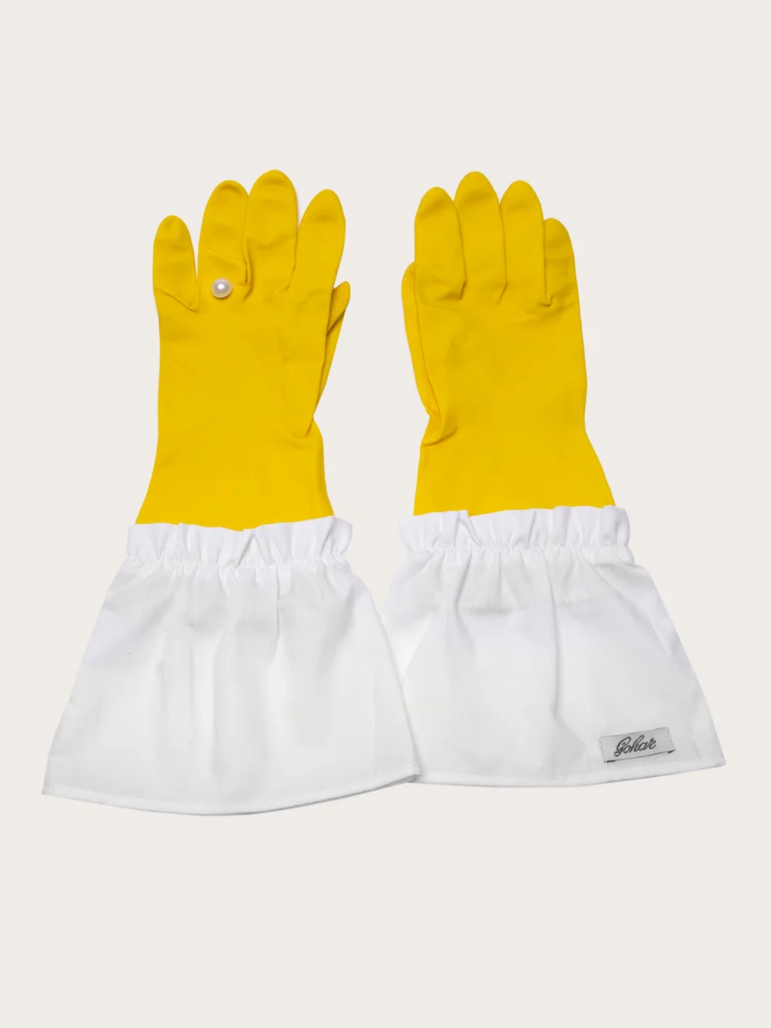 A pair of yellow kitchen gloves with a pearl embellishment
