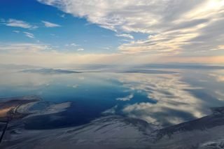 Clouds reflect from the remaining water in the Great Salt Lake