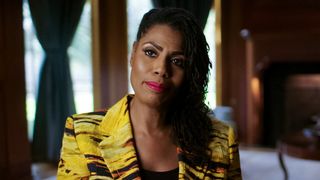 Former Celebrity Apprentice star Omarosa Manigault, wearing a gold and yellow jacket, appearing as one of the talking heads in a new Vice TV expose called Dark Side of Reality TV 2024