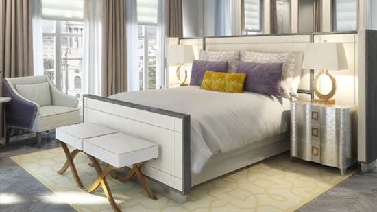 bedroom with bedside lamp wooden flooring and white arm chair and white window with curtains