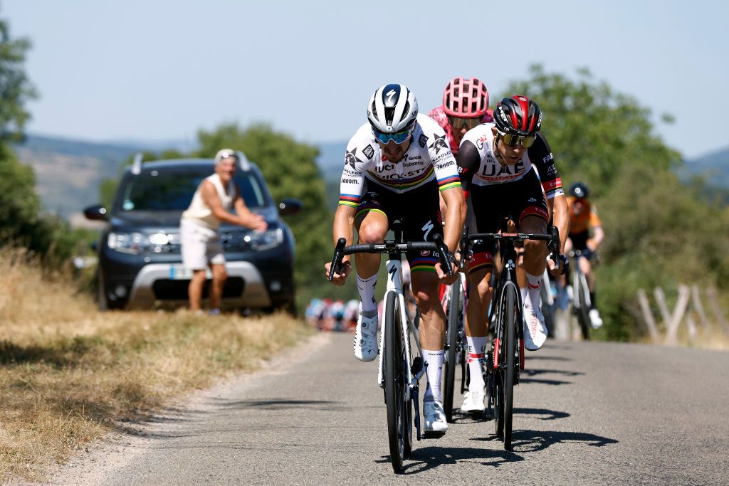 VALREVERMONT FRANCE AUGUST 09 Julian Alaphilippe of France and Team QuickStep Alpha Vinyl and George Bennett of New Zealand and UAE Team Emirates attack in the peloton during the 34th Tour de lAin 2022 Stage 1 a 152km stage from ChtillonSurChalaronne to ValRevermont TDA22 on August 09 2022 in ValRevermont France Photo by Bas CzerwinskiGetty Images