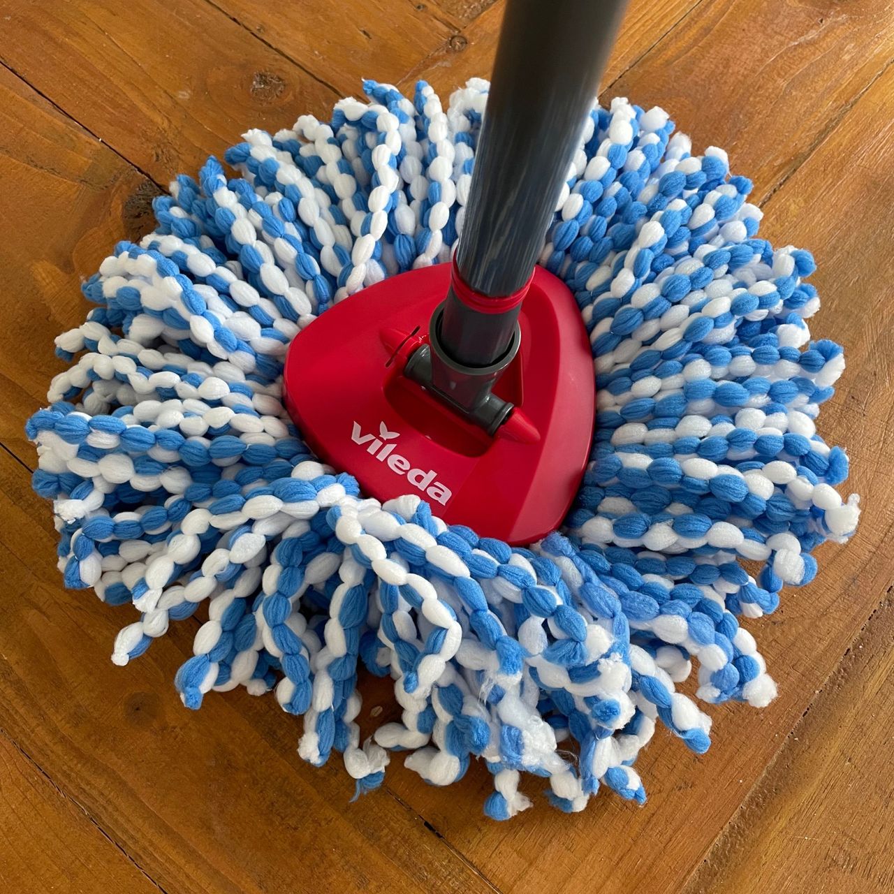 Vileda RinseClean Spin Mop &amp; Bucket System mop head on a wooden table