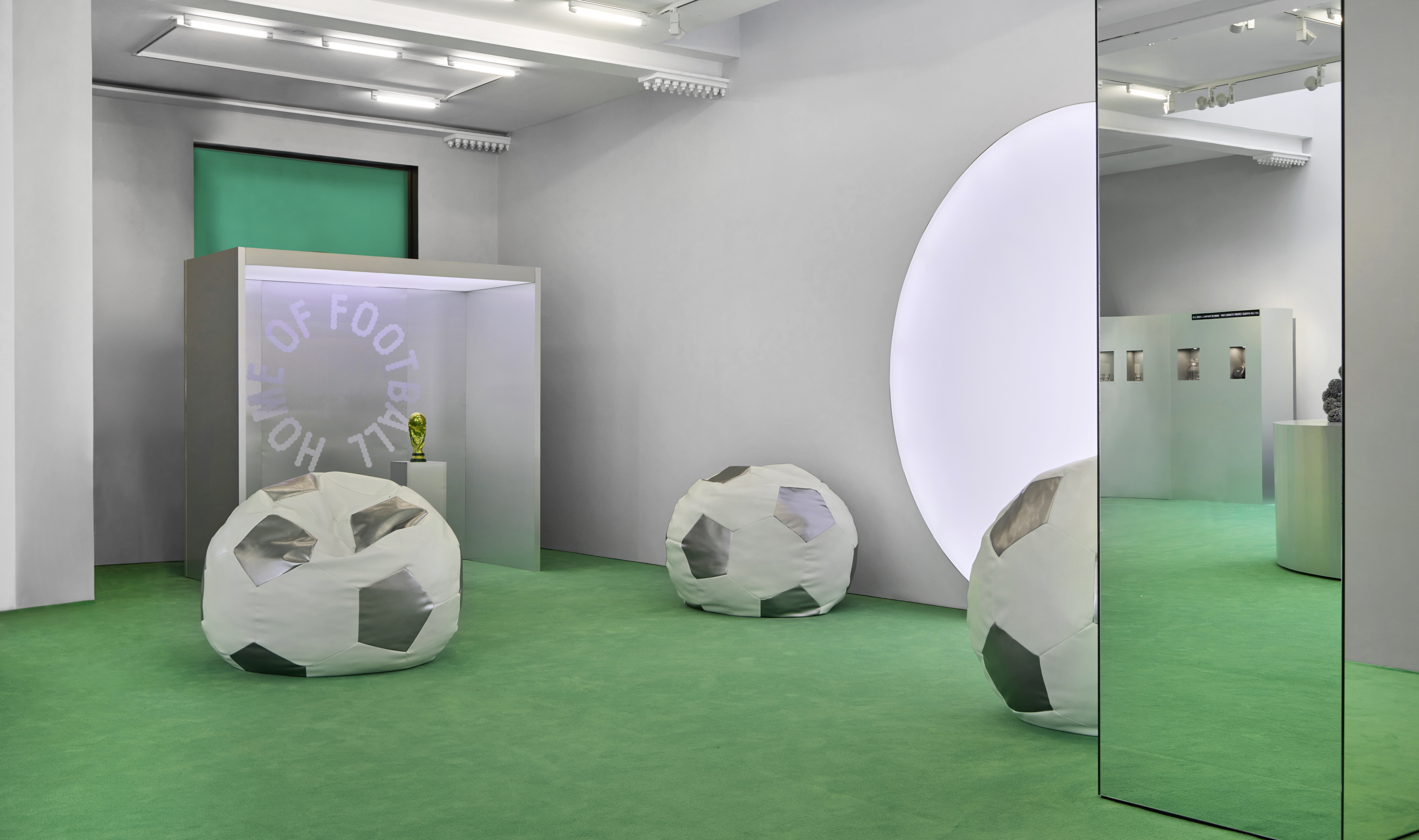 Inside Home of Football: Home &amp;amp; Away exhibition with pitch-green flooring and ball-shaped beanbag seating