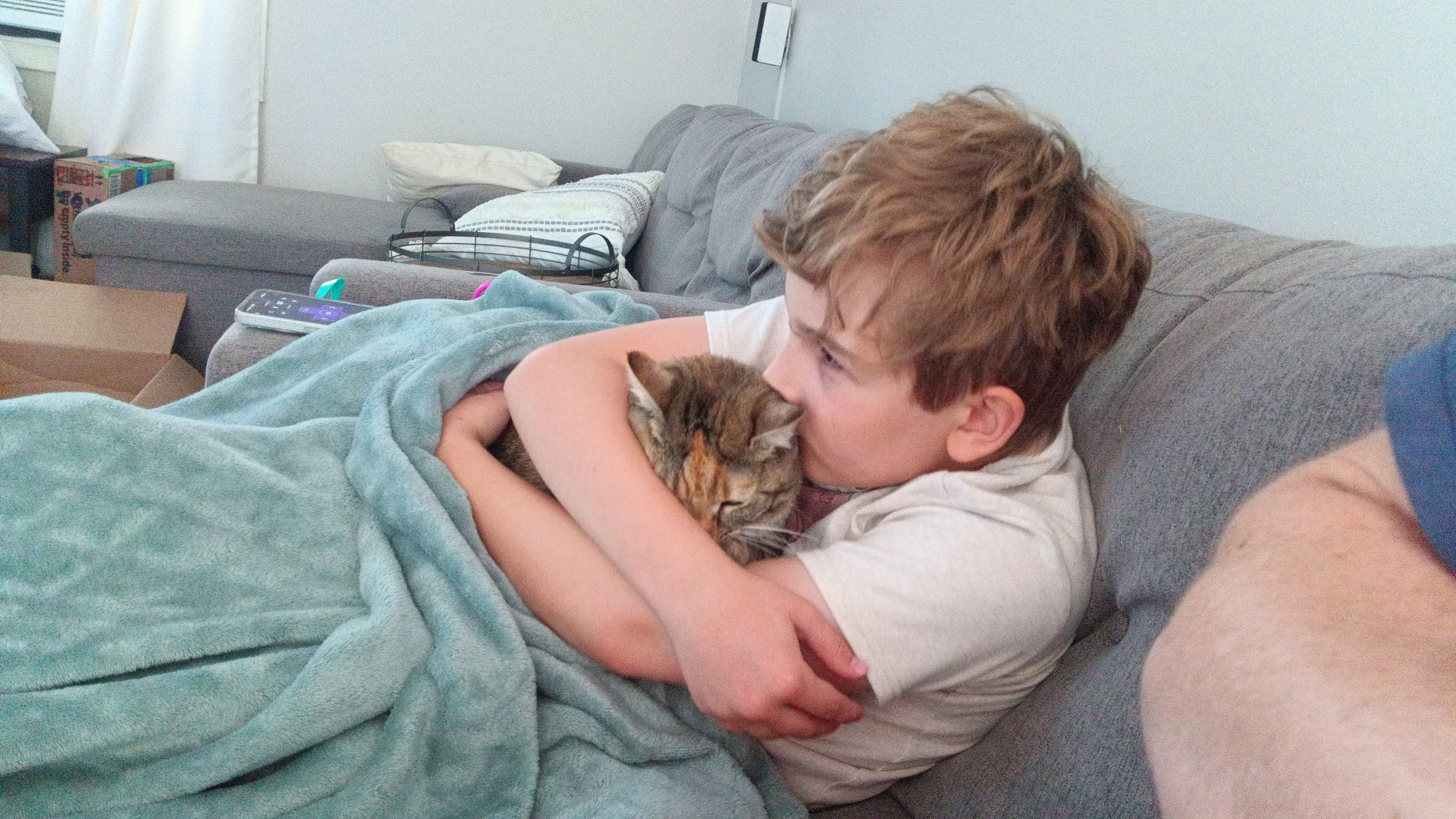 Camera samples from a Bigme HiBreak Pro E Ink smartphone showing a boy holding a cat