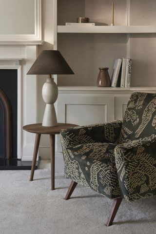 Patterned armchair with a modern side table and lamp
