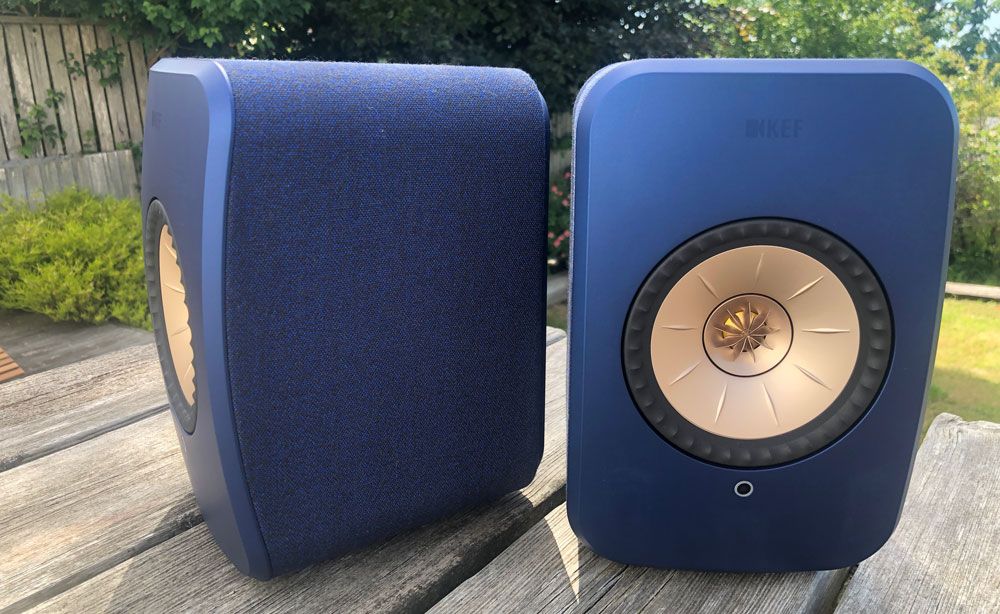 KEF LSX II speakers on a wooden table