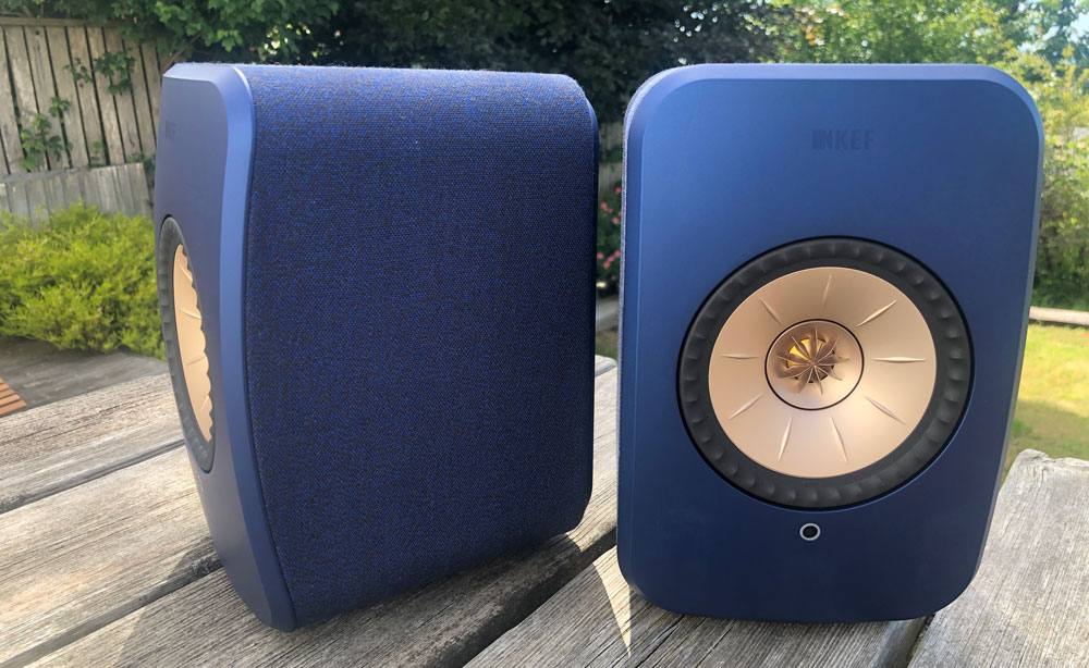 KEF LSX II speakers on a wooden table