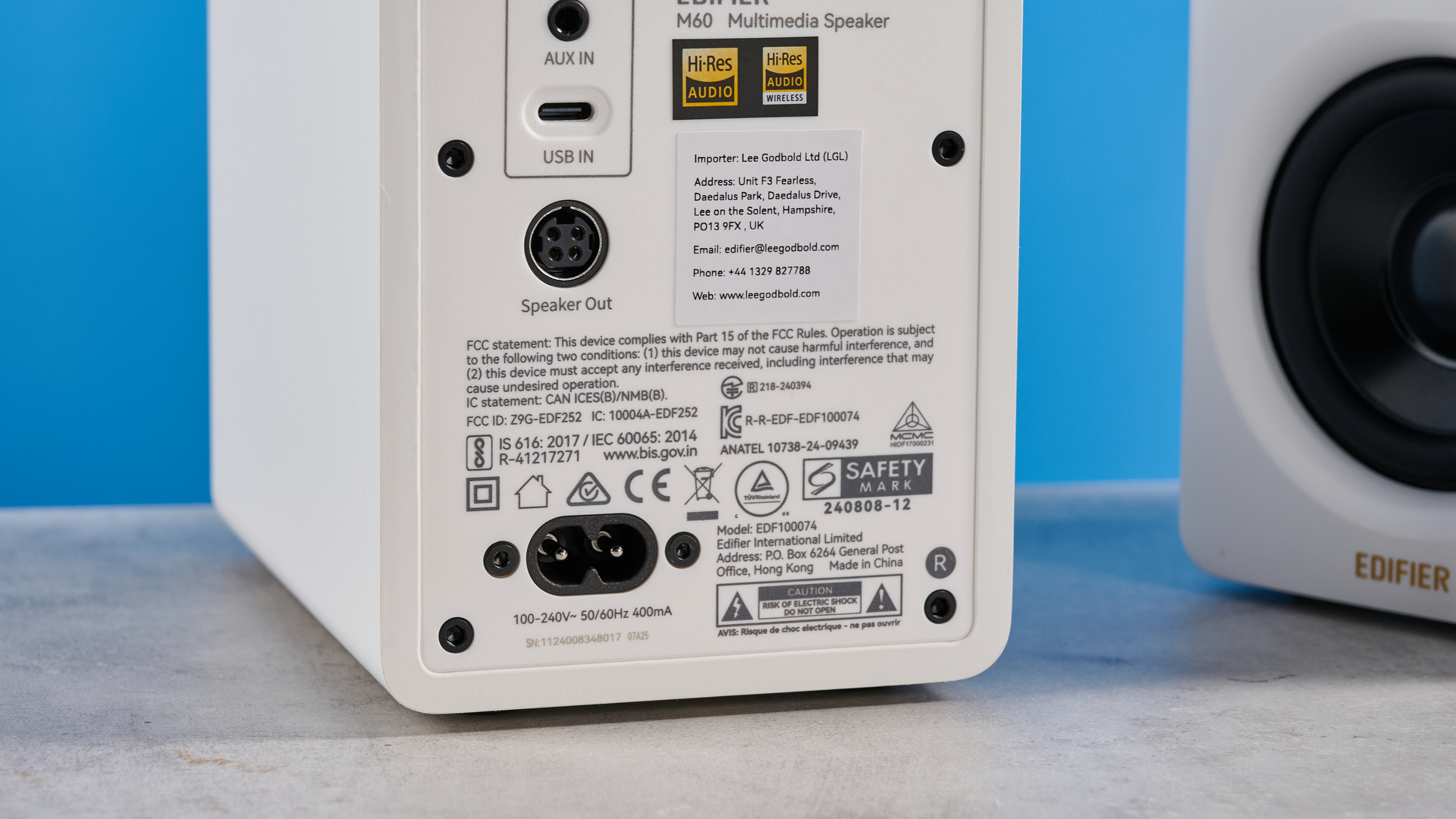 the edifier m60 bookshelf speakers in white photographed against the blue tom's guide background