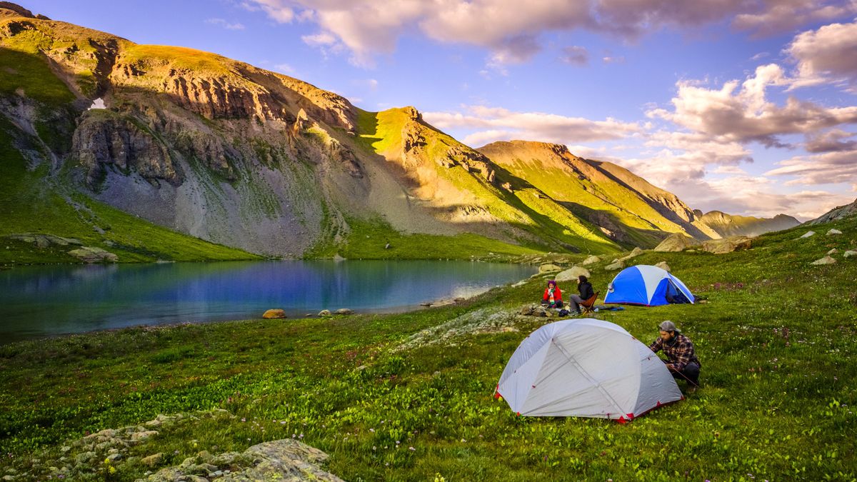 Clouds over small group of hikers camping in front of scenic Ice Lake, Colorado