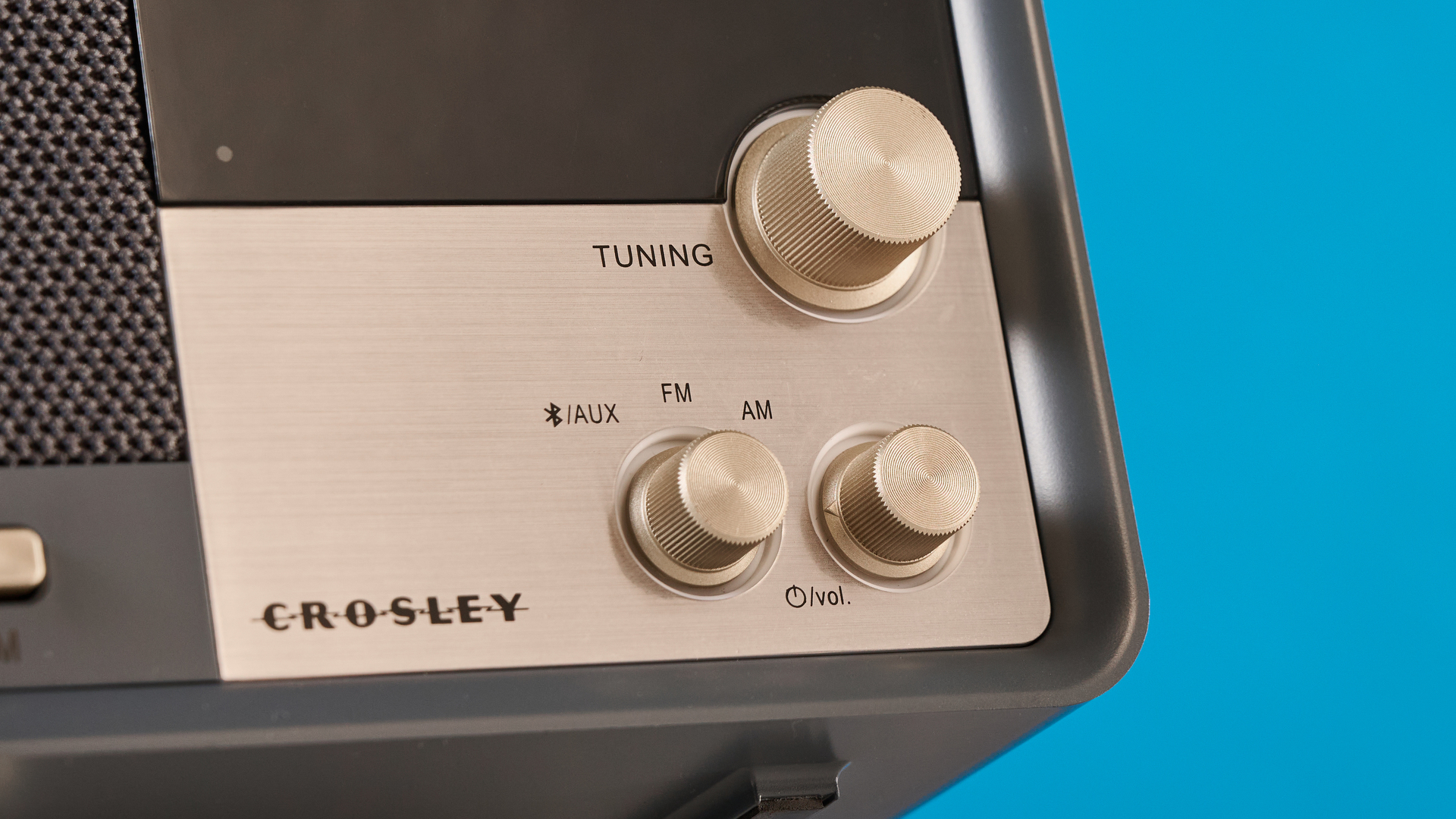 Crosley Tribute Radio in gray color photographed on a blue background