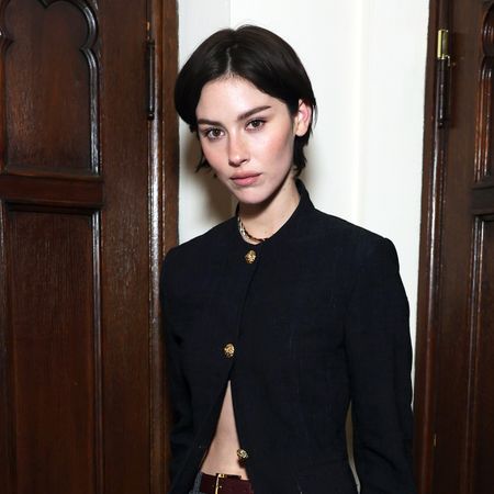 Gracie Abrams wearing a black blazer and gray trousers at the Coco Chanel event in Los Angeles