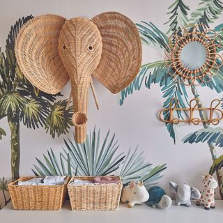 Chest of drawers in front of jungle wallpaper and wicker decorations