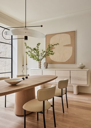 Minimalist dining room with oval wood table and modern white chairs
