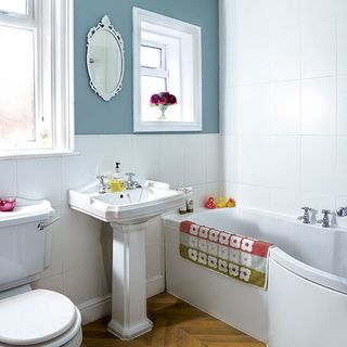bathroom with wash basin and white wall