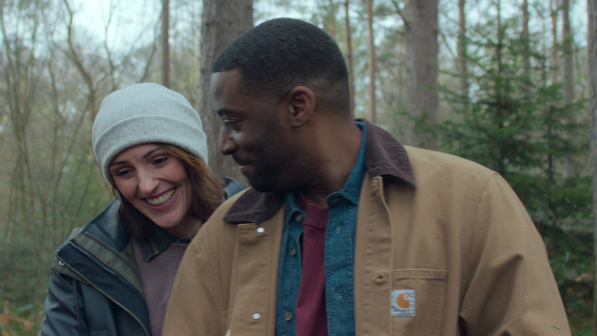 Abigail and Alex smile in the woods in Hostage
