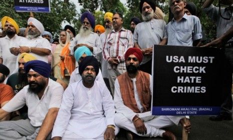 Indian Sikhs sit and pray in protest in New Delhi, India