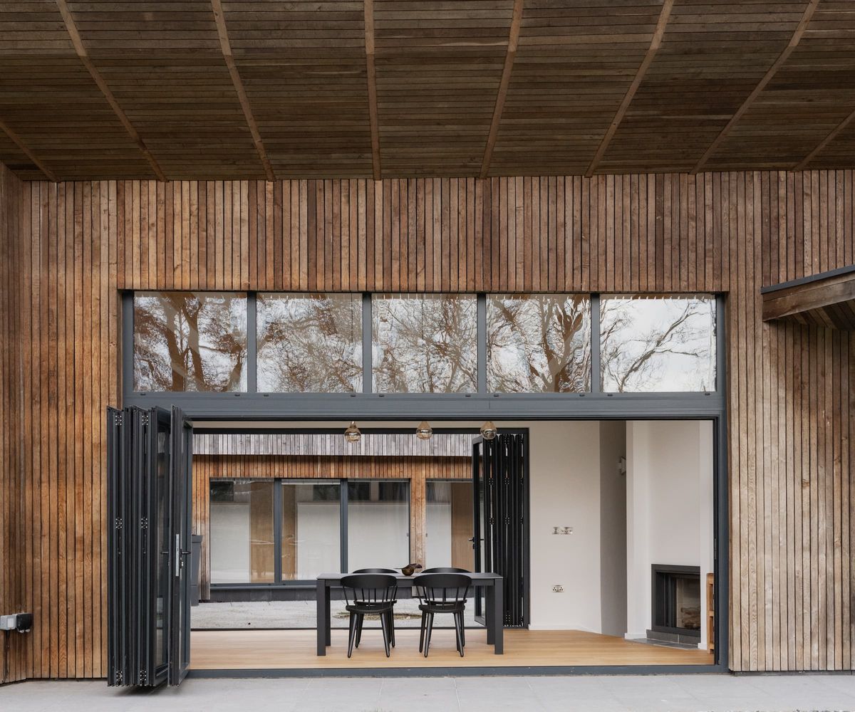 Timer cladding outside a self build with a dining area