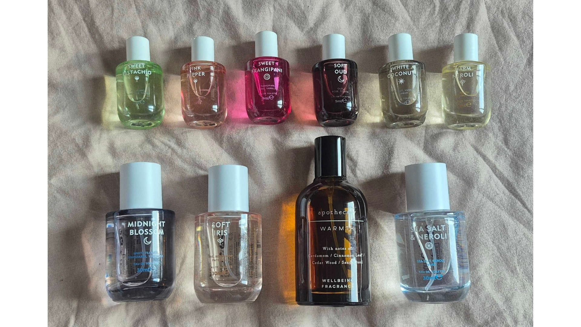 A picture showing 10 of M&amp;amp;S' perfumes laid out on a pink bedspread background.