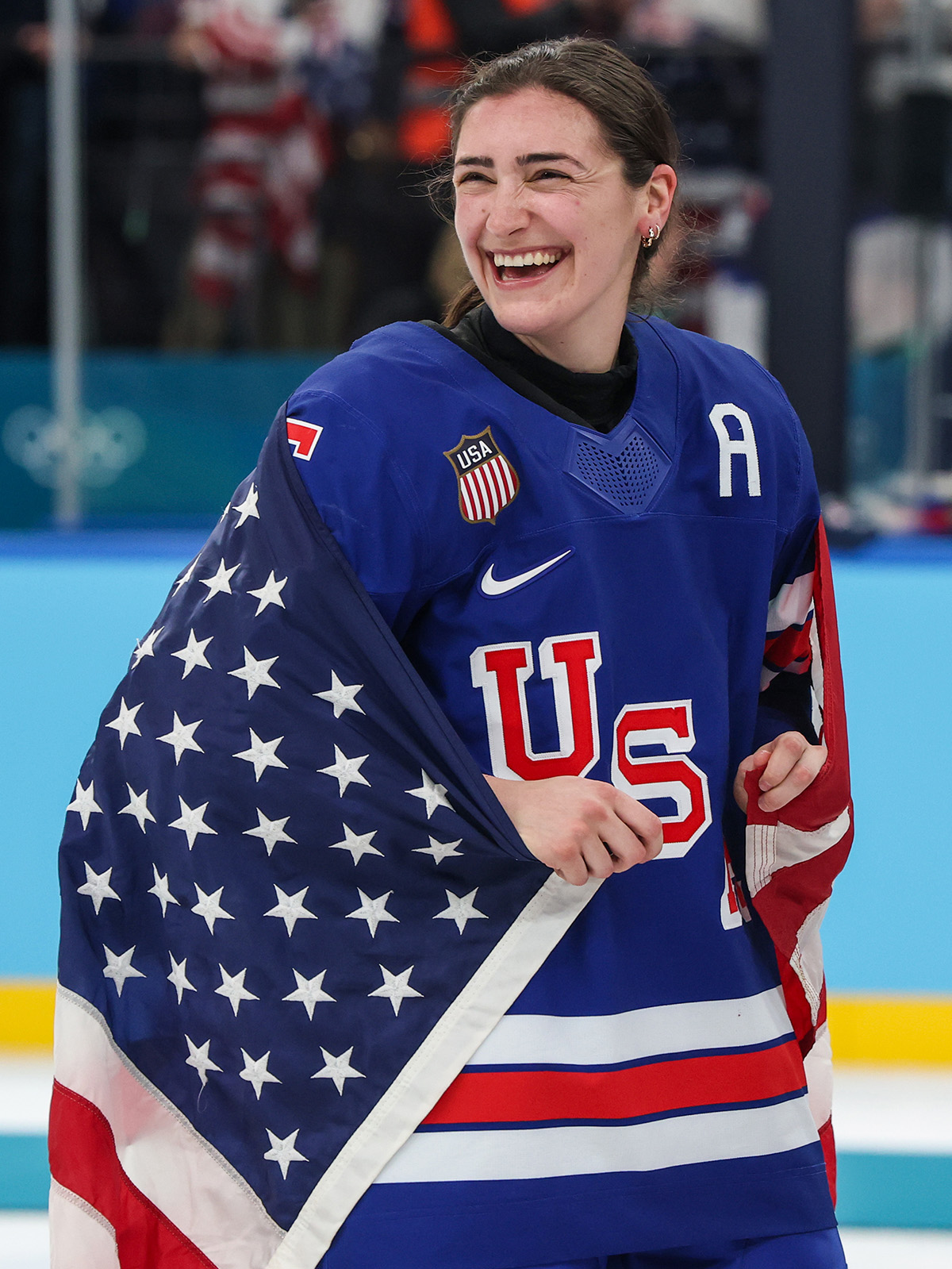 Milan, Italy, Thursday February 19, 2026 - Megan Keller basks in the glow of victory after she scored the game winning goal in overtime to beat Canada 2-1 in the Women's ice hockey final at Milano Santagiulia Ice Hockey Arena.